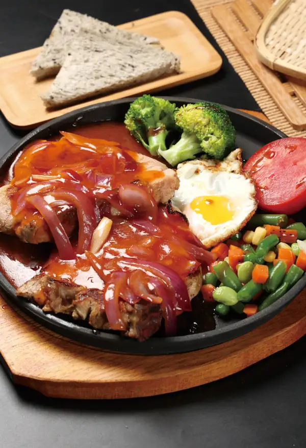 Sizzling Pork Steak In Iron Plate